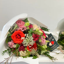 Load image into Gallery viewer, The Amore Bouquet in standard size, featuring Ferrari red roses, wine-toned blooms, and seasonal flowers, wrapped in white paper with velvet ribbons. Includes flower food for freshness.