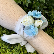 Load image into Gallery viewer, Close-up of Blue Mirage Adelaide's Dream Corsage highlighting the delicate white chiffon ribbon and the intricate arrangement of silk flowers and dried blue hydrangea.