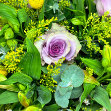 Load image into Gallery viewer, A close-up image of a stunning pastel rose arrangement featuring pink and purple roses with delicate lavender accents. The vibrant roses and lush green foliage create a soft, elegant look, highlighting the fine details of the fresh blooms in this beautiful floral display.