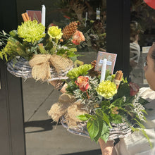 Load image into Gallery viewer, Decorative floral Christmas arrangement with greenery, flowers, and burlap accents on a table.