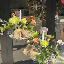 Load image into Gallery viewer, Christmas floral arrangements with burlap accents displayed in a store window.