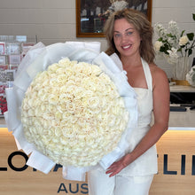 Load image into Gallery viewer, Woman holding a large bouquet of white flowers at Floral Atelier Australia the only one place where to order 200 stems rose bouquet in Adelaide