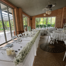 Load image into Gallery viewer, White faux Baby's Breath bridal table garland creating a continuous floral runner along a wedding reception table at Glen Ewin Estate in Adelaide.