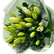 Load image into Gallery viewer, This elegant bouquet showcases the timeless beauty of white lilies, thoughtfully arranged to create a luxurious and lasting impression. 
