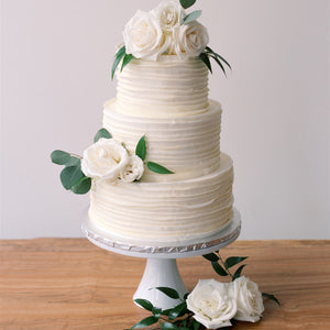 Fresh white roses and greenery decorating a wedding cake – Floral Atelier Australia