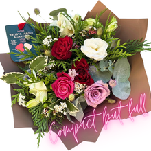 Load image into Gallery viewer, A charming compact-sized bouquet featuring classic roses and seasonal flowers in shades of red, soft pink, and subtle tones. Paired with lush greenery and wrapped in chocolate brown paper, this bouquet is perfect for thoughtful gestures.
