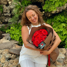 Load image into Gallery viewer, A dozen Ferrari red roses arranged with delicate fillers, lush green foliage, and elegant wrapping, perfect for a romantic or thoughtful gift.
