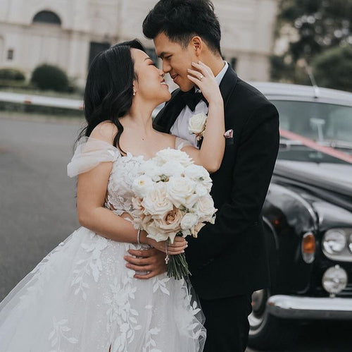 White and Quicksand Rose Bridal Bouquet by Floral Atelier Australia – reflexed Ecuador roses with seasonal white flowers in a hand-tied design.