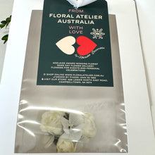 Load image into Gallery viewer, Close-up of the Pure Bliss Adelaide&#39;s White Corsage, highlighting the silk spray roses and complementary white botanicals, embodying a young and elegant design
