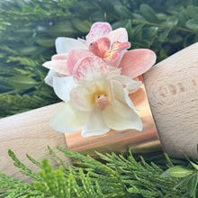 Load image into Gallery viewer, The Rose Gold Orchid Corsage Cuff elegantly fitted on a wrist, demonstrating its adjustable, free-size design for a perfect fit on any wrist size.
