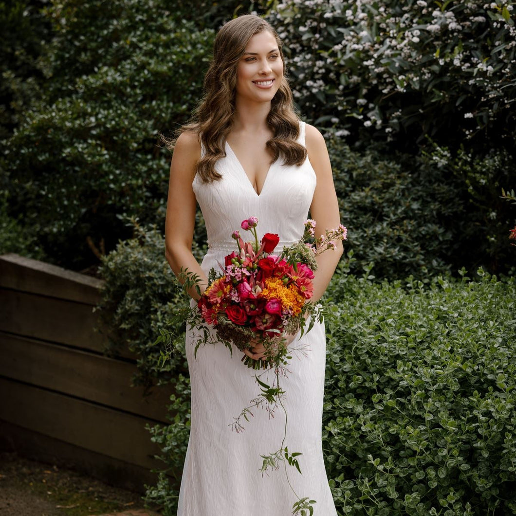 Summer Flame bridal bouquet with fire-toned ranunculus, pink accents, trailing jasmine, and greenery – Floral Atelier Australia, Adelaide wedding florist.