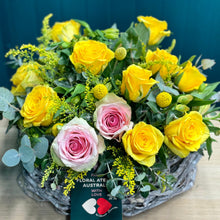 Load image into Gallery viewer, A generous bouquet featuring a mix of pink and yellow roses, alstroemerias, yellow billy buttons, golden rod, and blue gum, arranged in a deluxe size to make a bold and joyful statement
