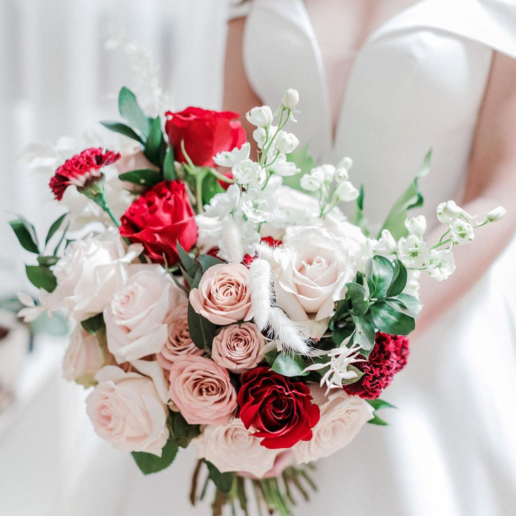 Warm Embrace bridal bouquet with red, white, and cappuccino roses, delphinium, bunny tails, and greenery – Floral Atelier Australia, Adelaide wedding florist.