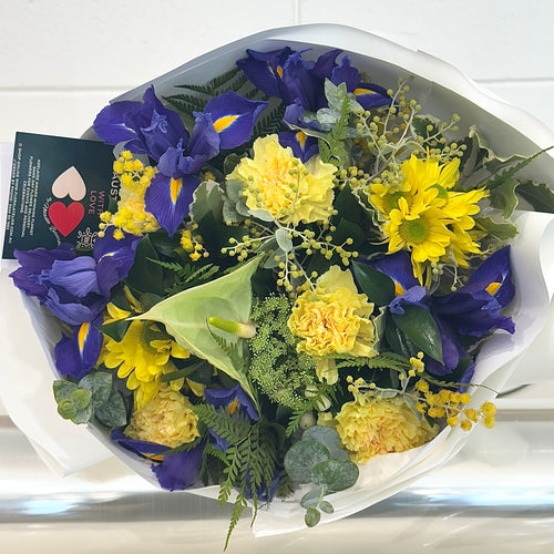 Seasonal Yellow and blue bouquet front view made by talented florist in Adelaide.