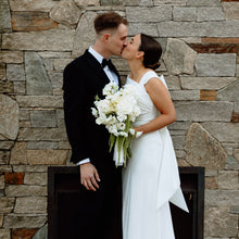 Load image into Gallery viewer, A modern cascading bouquet with soft lines and elegant movement — designed for the refined bride who loves clean beauty with a cloud-like feel.

This bouquet features reflexed Play Bianca Ecuador roses at its core, accented by sculptural white calla lilies, airy lisianthus, and delicate dancing white scabiosa. Long green amaranthus trails below, creating soft vertical direction in a white and green palette.
Balanced and understated, this bouquet perfectly complements structured bridal gowns and minimal .
