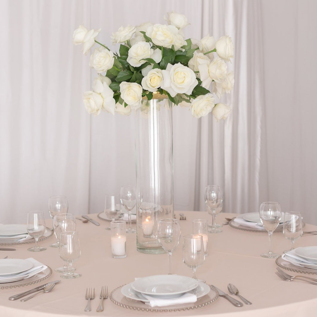 White rose centerpiece on tall glass vase – elegant guest table floral design by Floral Atelier Australia.