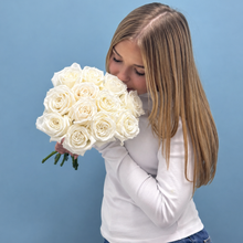 Load image into Gallery viewer, Teenager holding a bouquet of white roses she purchased for her nonna for Mother's Day
