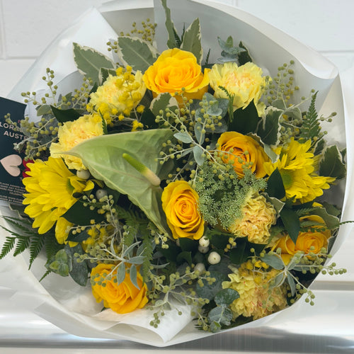 Yellow Acacia and Wattle Bouquet with foliage wrapped in white paper