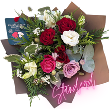 Load image into Gallery viewer, A balanced, medium-sized bouquet with classic roses and seasonal flowers in red, soft pink, and gentle tones. Complemented by lush greenery and wrapped in chocolate brown paper, it’s an ideal choice for most occasions.
