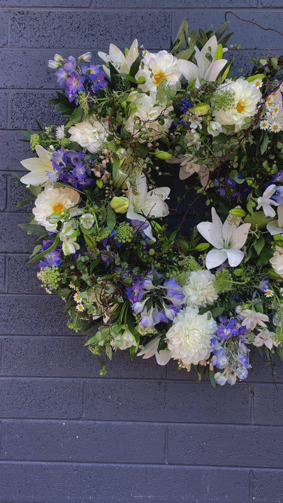 A heartfelt video showcasing the Freedom Bloom Wreath, dedicated to Alexey Navalniy, featuring white blooms, wild forest foliage, and hints of blue flowers symbolizing peace, strength, and freedom. This 45 cm wreath is crafted to offer sympathy and support during difficult times.