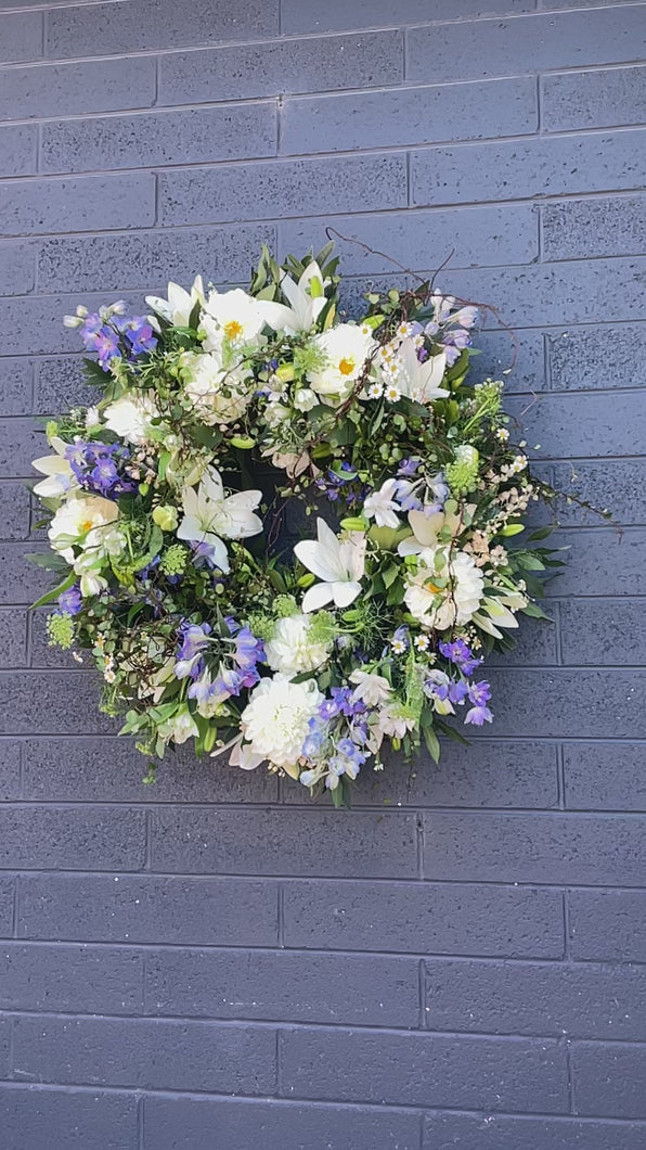 A heartfelt video showcasing the Freedom Bloom Wreath, dedicated to Alexey Navalniy, featuring white blooms, wild forest foliage, and hints of blue flowers symbolizing peace, strength, and freedom. This 45 cm wreath is crafted to offer sympathy and support during difficult times.