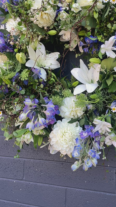 A heartfelt video showcasing the Freedom Bloom Wreath, dedicated to Alexey Navalniy, featuring white blooms, wild forest foliage, and hints of blue flowers symbolizing peace, strength, and freedom. This 45 cm wreath is crafted to offer sympathy and support during difficult times.