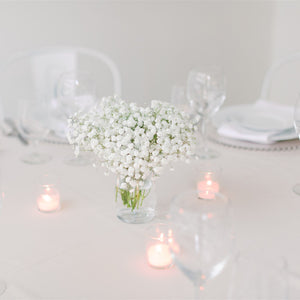 Small baby’s breath centerpiece in a glass jar with 3 tea candles – ideal for cocktail tables and intimate weddings by Floral Atelier Australia, Adelaide