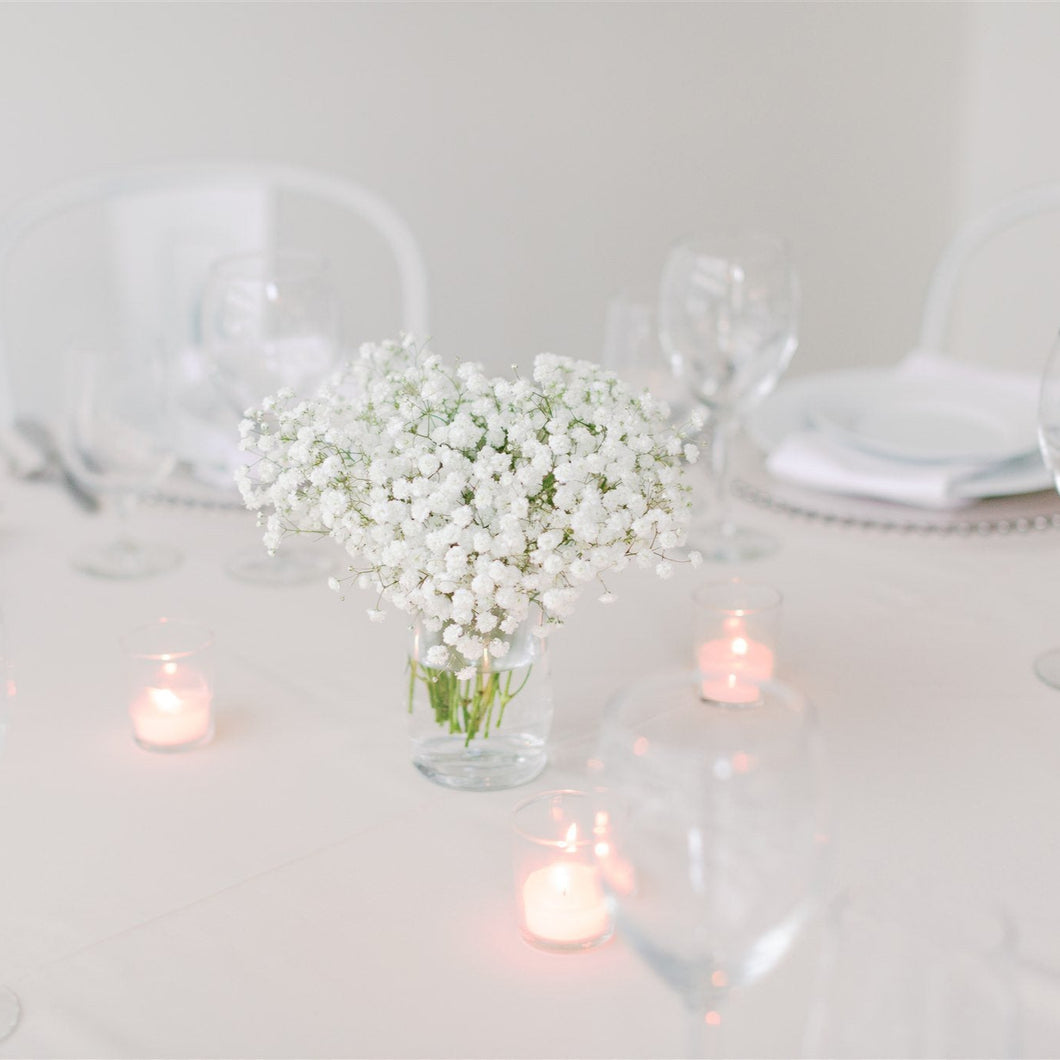 Small baby’s breath centerpiece in a glass jar with 3 tea candles – ideal for cocktail tables and intimate weddings by Floral Atelier Australia, Adelaide
