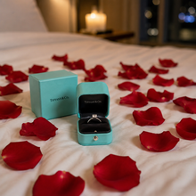 Load image into Gallery viewer, Tiffany ring proposal setup with fresh red rose petals on a hotel bed, romantic engagement styling idea by Floral Atelier Australia Adelaide florist.
